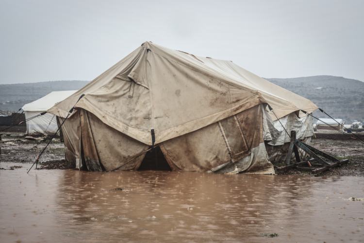 <p>Çadırların içine giren yağmur suyunu tahliye etmeye çalıştıklarını belirten Hammade, "Yağmur yağmaya devam ediyor, bizim gidecek yerimiz yok, çadırlarımız sular altında." diye konuştu.</p>  